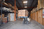 Forklift handling palletized materials in climate controlled warehouse
